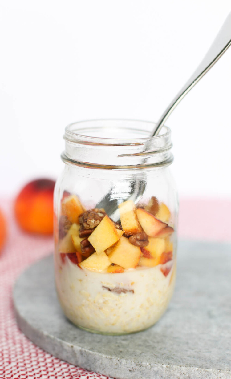 Peach Pie Overnight Oats ingredients layered in a mason jar.