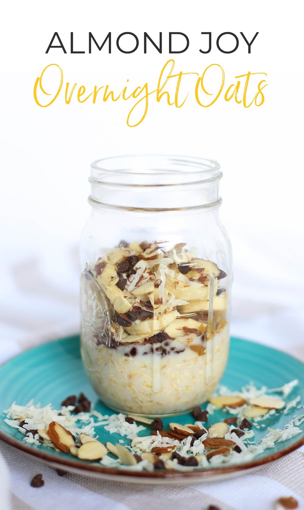 Almond Joy Overnight Oats in a mason jar on top of turquoise plate with coconut, sliced almonds, and chocolate chips scattered around.