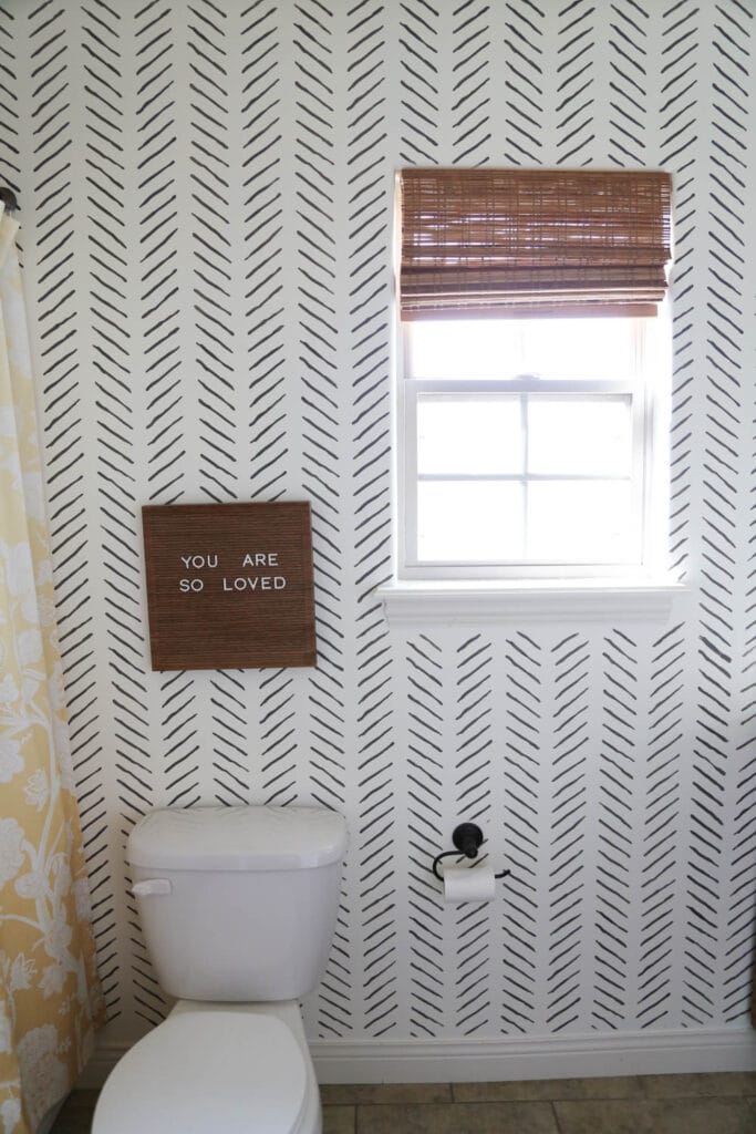 Hand drawn chevron bathroom stencil on a white wall 