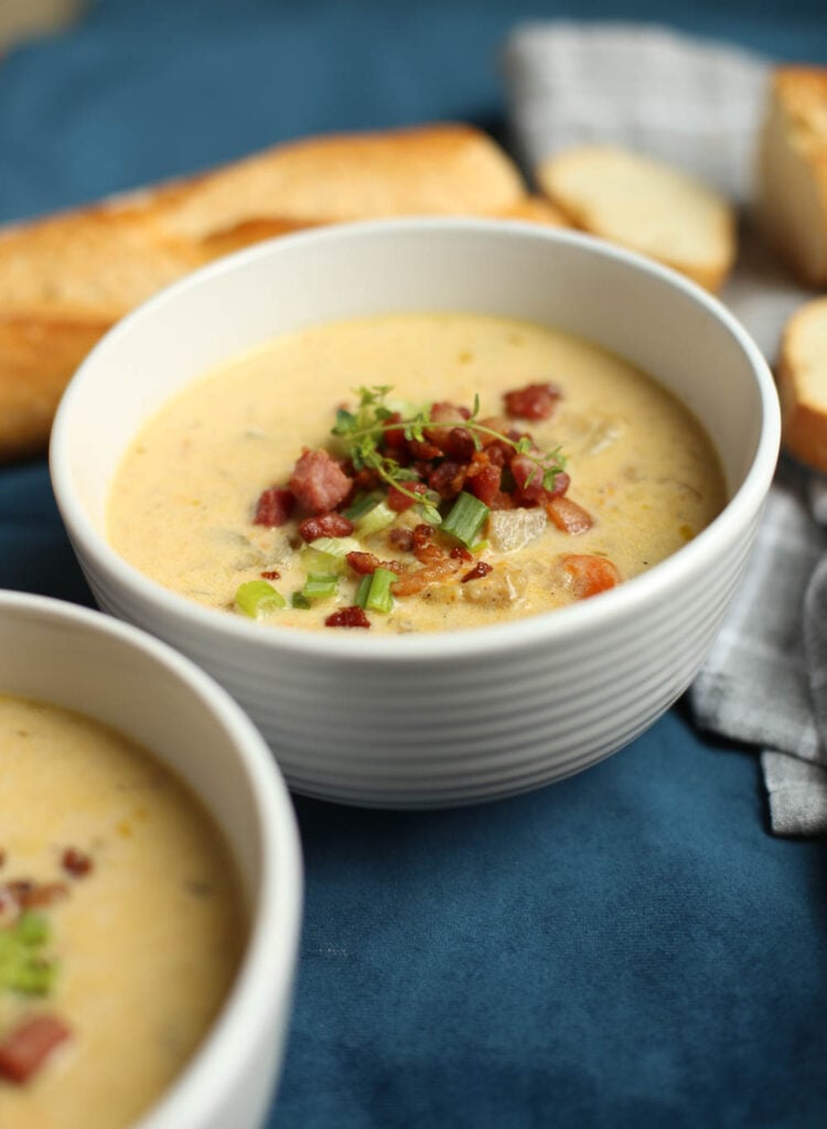 Slow cooker cheddar and bacon potato soup in a white bowl