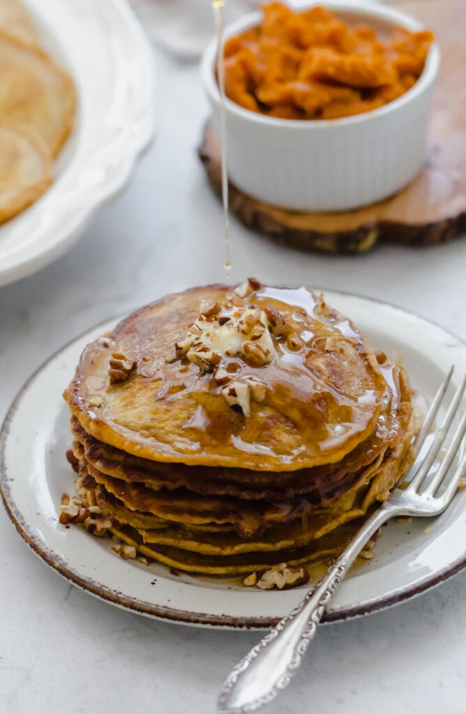 whole wheat pumpkin panckes with syrup on top