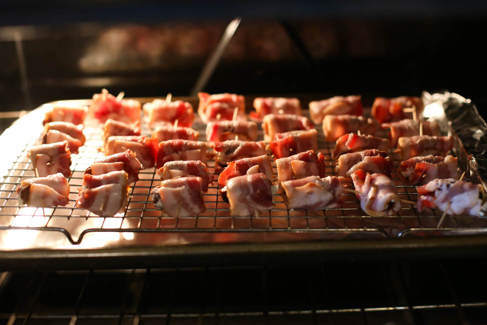 Bacon-Wrapped Dates with Goat Cheese on a baking rack