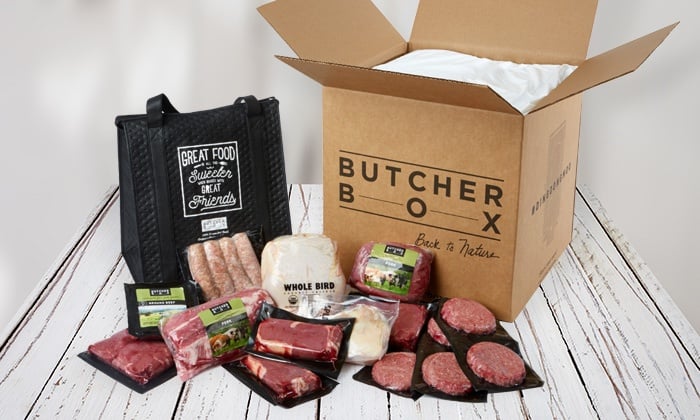 A large box with Butcher Box on the front and several packages of various cuts of meat surrounding it.
