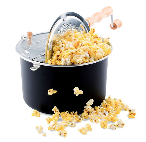 Whirlypop stovetop machine - looks like a black stock pot with silver lid and wooden handle as well as popcorn spilling out of it.