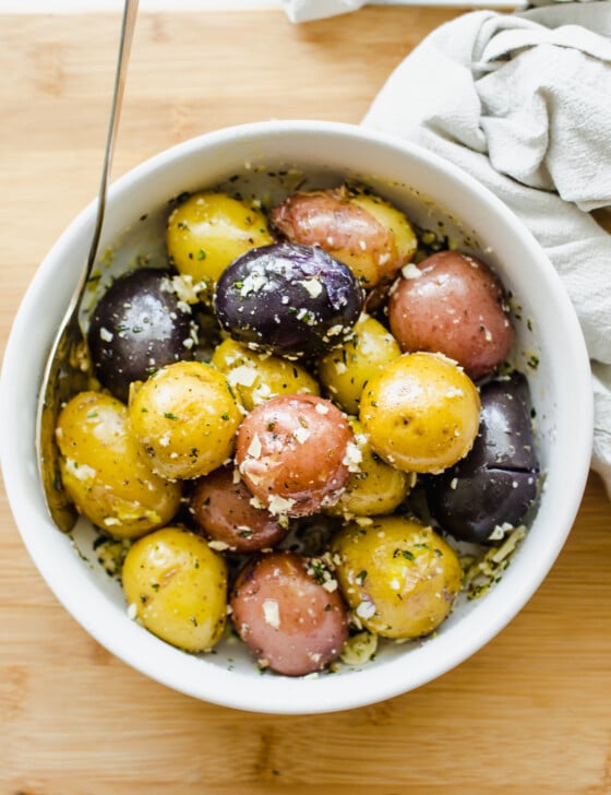 Boiled baby potatoes in a white bowl.