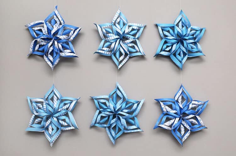 Paper snowflakes made of strips of paper rolled and folded and stapled together.