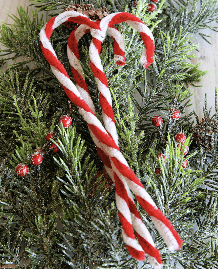 Three pipe-cleaner candy canes made by twisting red and white pipe cleaners together and then making it a cane shape.