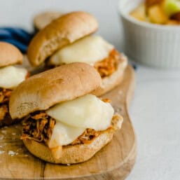 Chicken parmesan sliders on a cutting board.