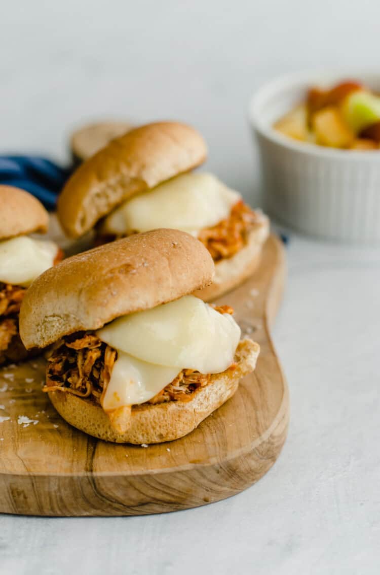 Chicken parmesan sliders on a cutting board.