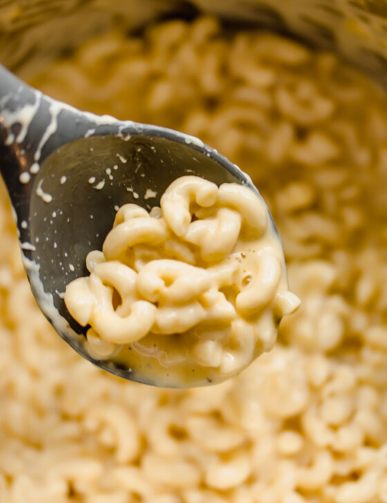 Spoon with Instant Pot Mac and Cheese being lifted out of an instant pot.