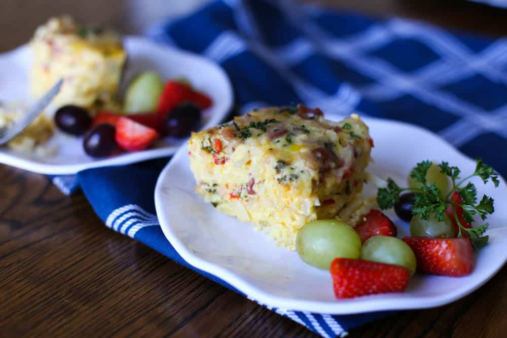 Breakfast Casserole slice on a plate with fruit