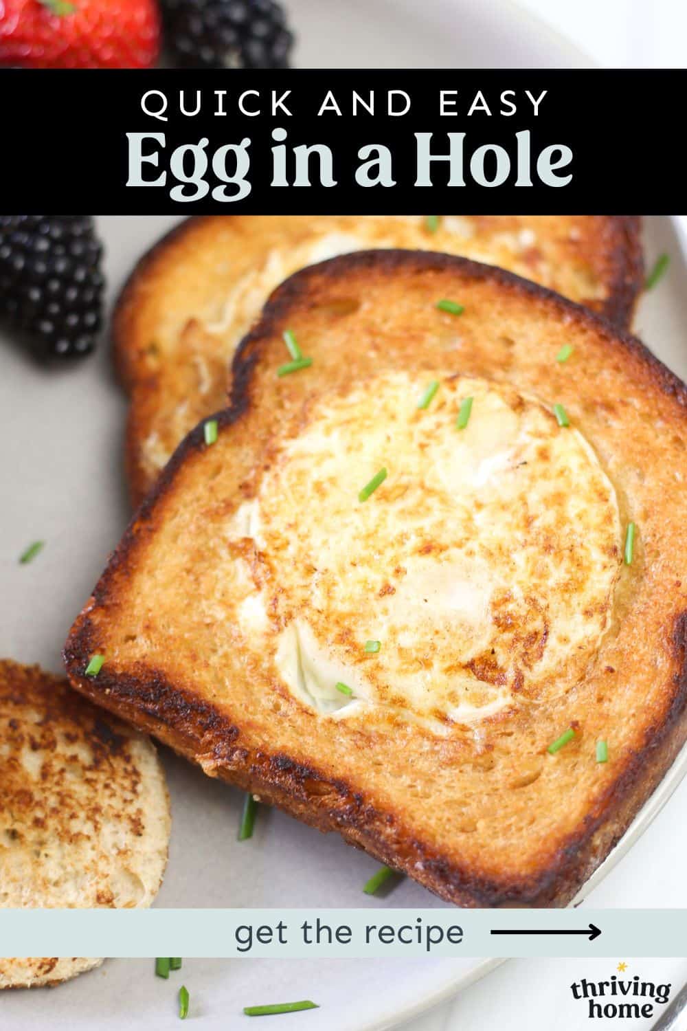 Two slices of toasted bread with eggs cooked in the middle, called egg in a hole.
