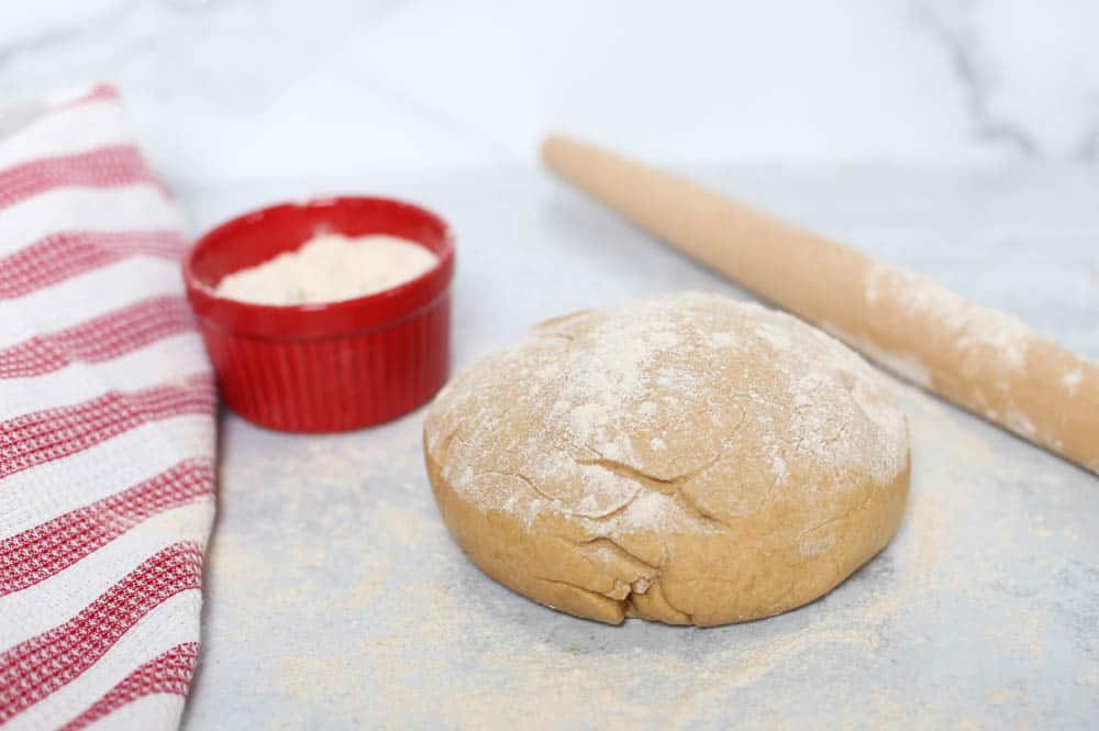 Homemade pizza dough with flour sprinkled on top