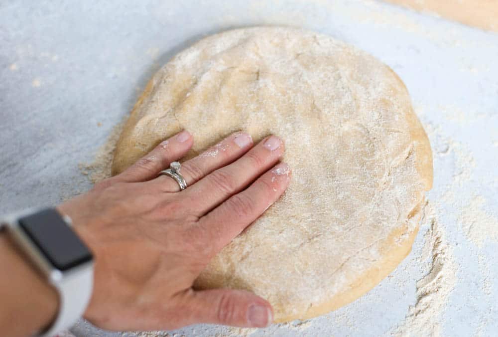 Homemade pizza dough being rolled out