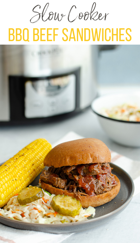 Slow cooker bbq beef sandwich on a plate with corn.