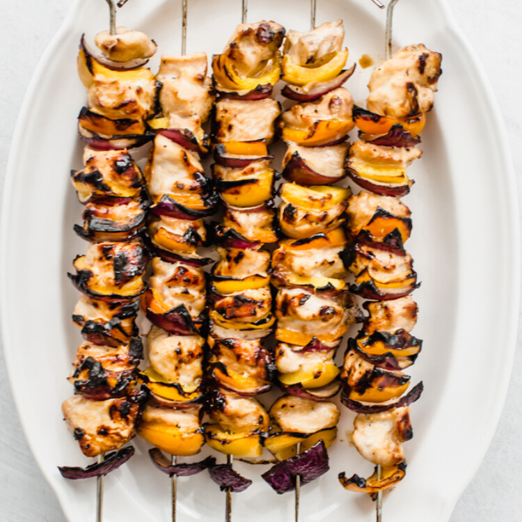 Cooked Honey garlic chicken kabobs on a white plate