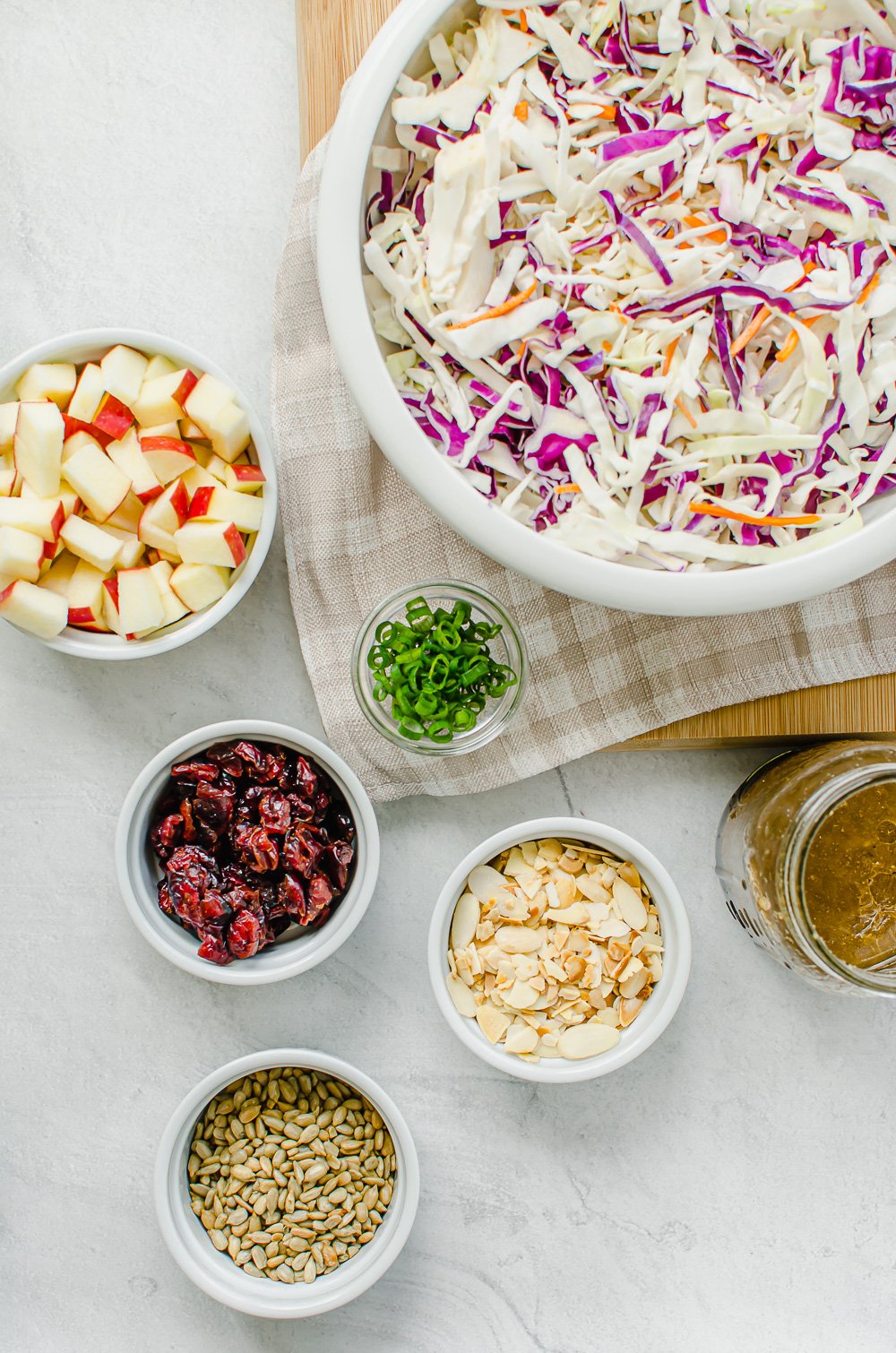 Ingredients for Asian Slaw measured out in bowls.