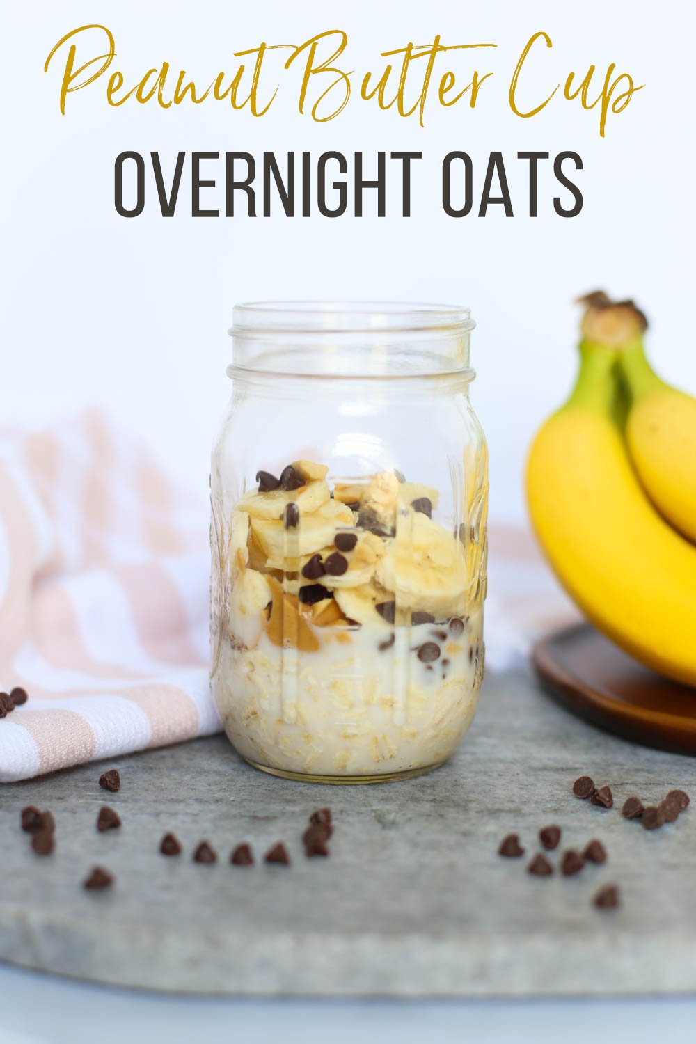 Oats, milk, peanut butter, chocolate chips, and bananas in mason jar on a counter.