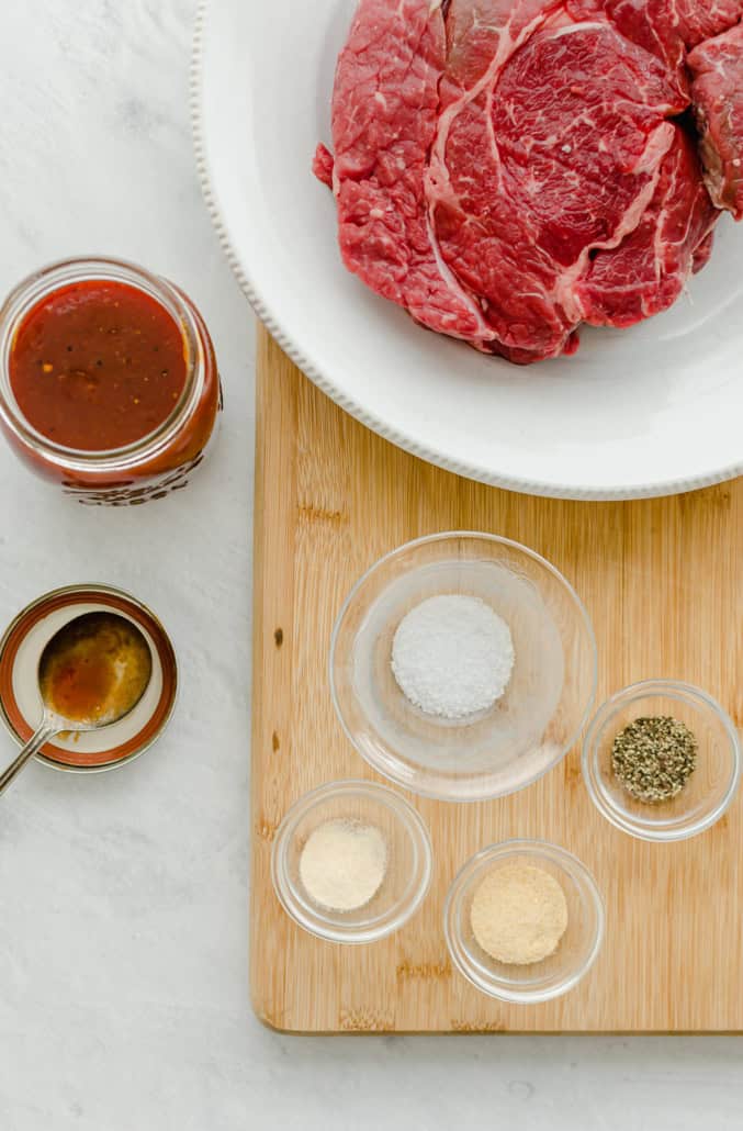 ingredients for bbq shredded beef on a cutting board