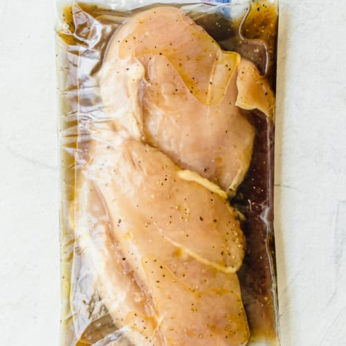 chicken breasts in marinade in a gallon sized freezer bag