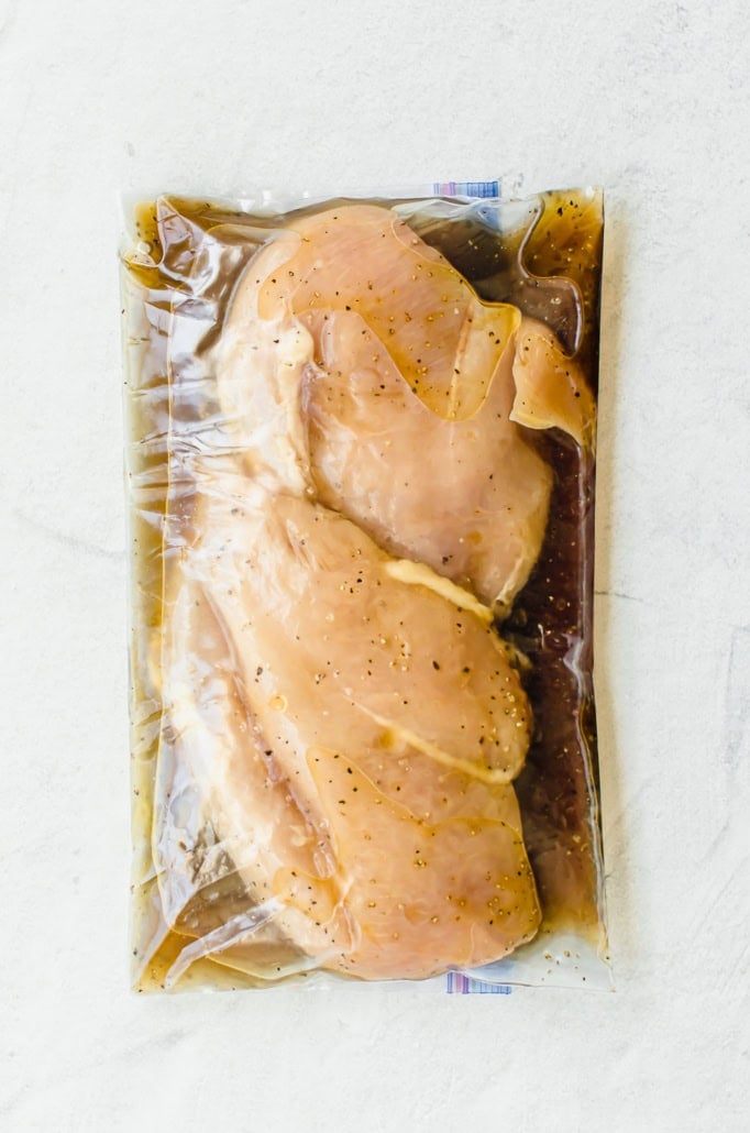 chicken breasts in marinade in a gallon sized freezer bag