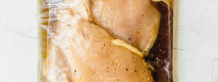 chicken breasts in marinade in a gallon sized freezer bag