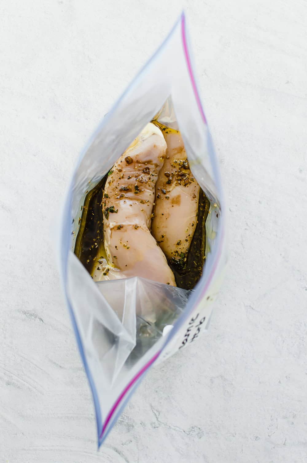 Chicken breasts in freezer bag with balsamic herb marinade.