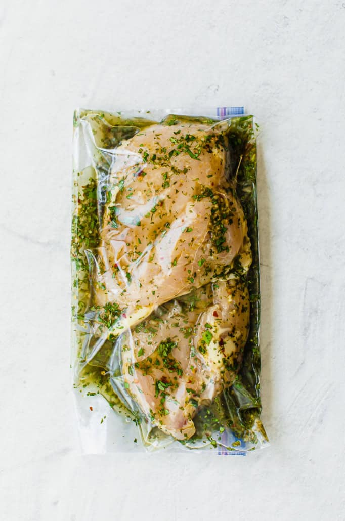 Cilantro lime marinade and chicken breasts in a sealed freezer bag.