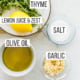 Fresh lemon, garlic, thyme, salt, and olive oil in small bowls