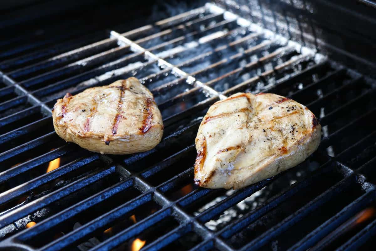 Grilled chicken breasts on the grill.