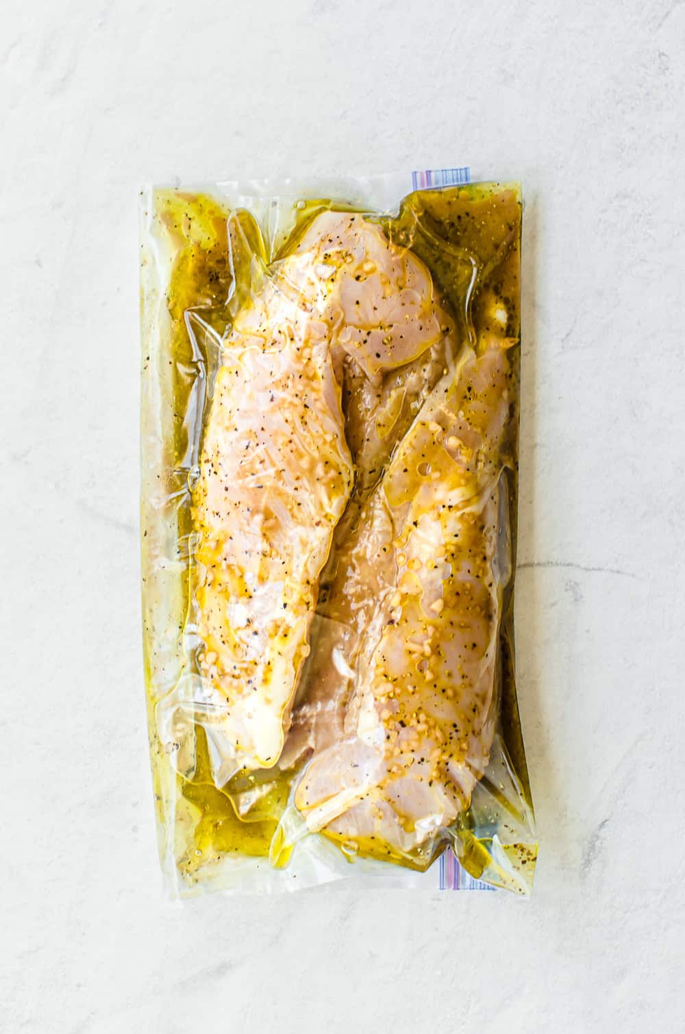 savory chicken marinade in savory chicken marinade in a freezer bag with chicken breasts