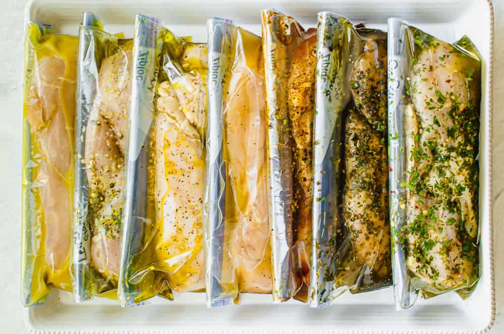 Marinades for chicken breasts in freezer bags lined up in the freezer.