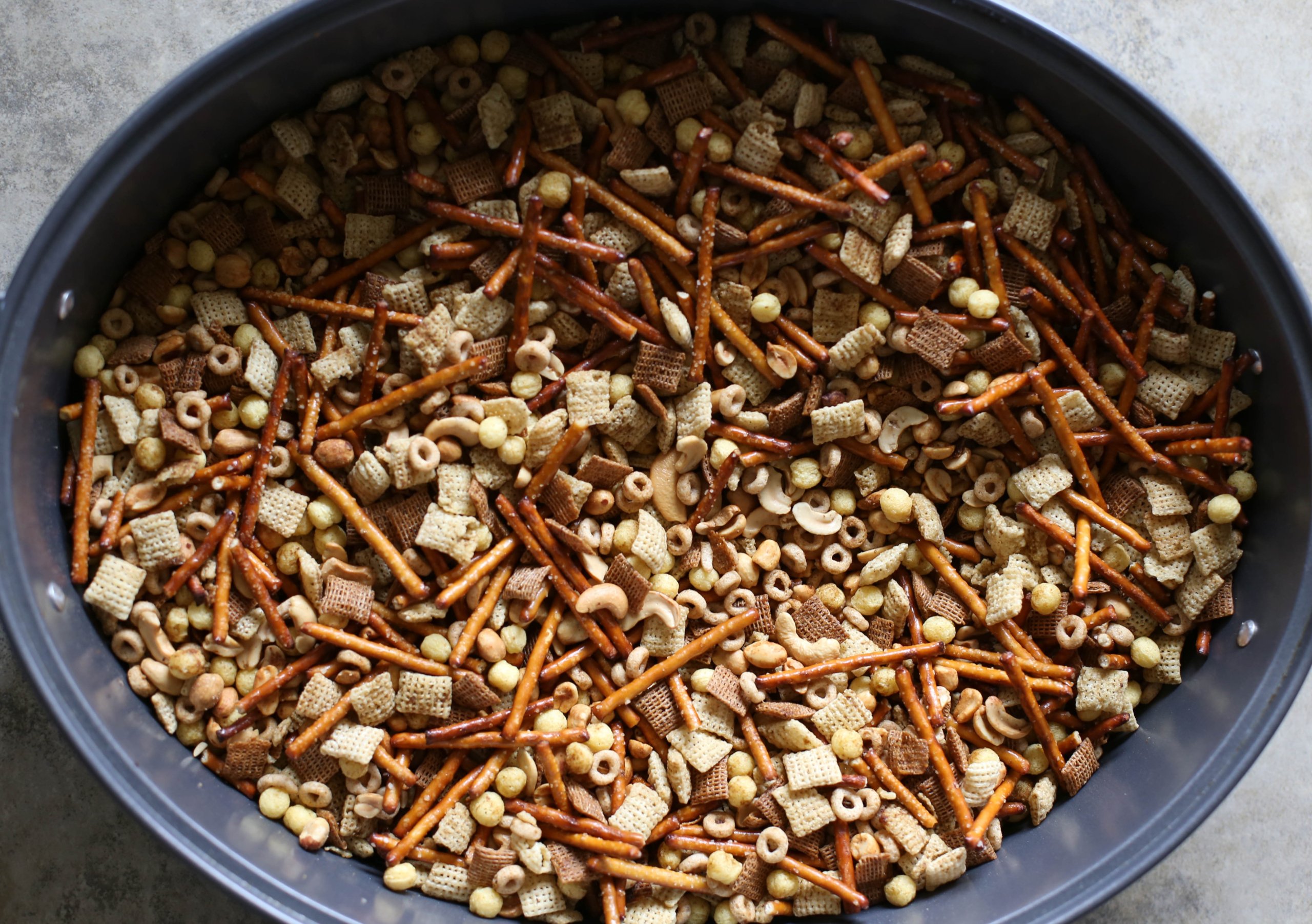 Finished Homemade Chex Mix in a large roasting pan ready to be dished out.