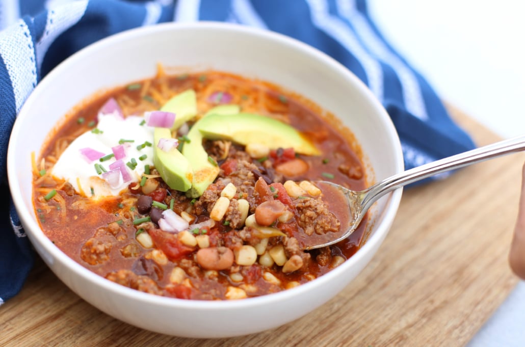 Mexican soup with toppings and spoon