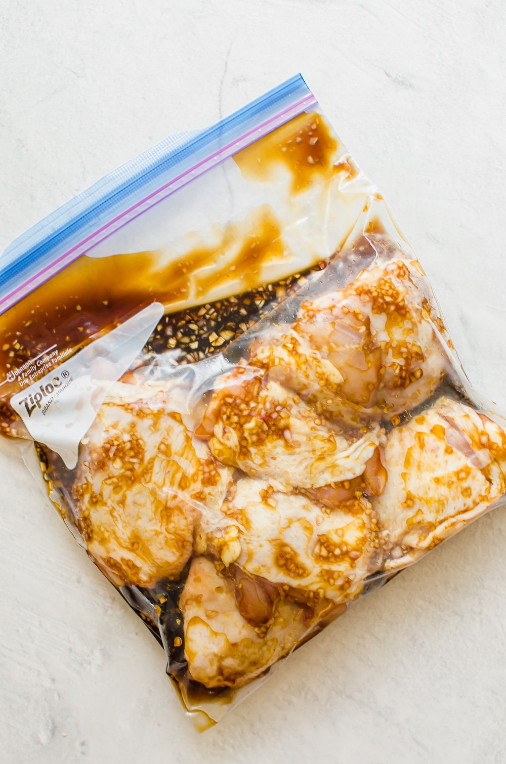 Chicken thighs in a freezer bag with teriyaki marinade.