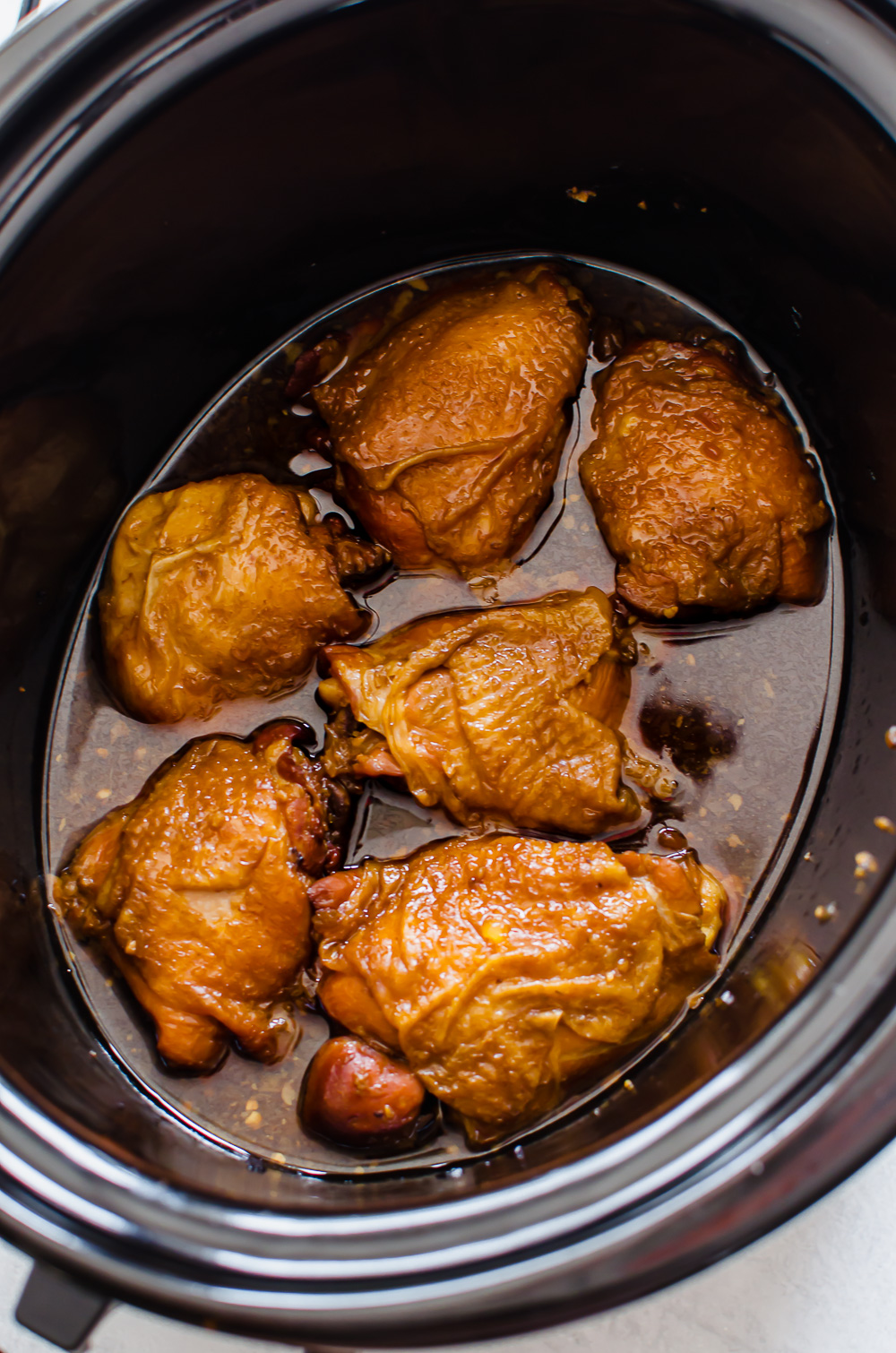 Teriyaki chicken thighs in a slow cooker ready to be served.