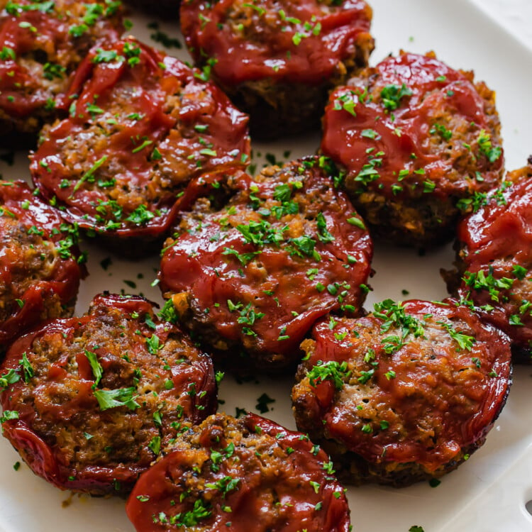 Mini meatloaf muffins lined up on a platter ready to serve.
