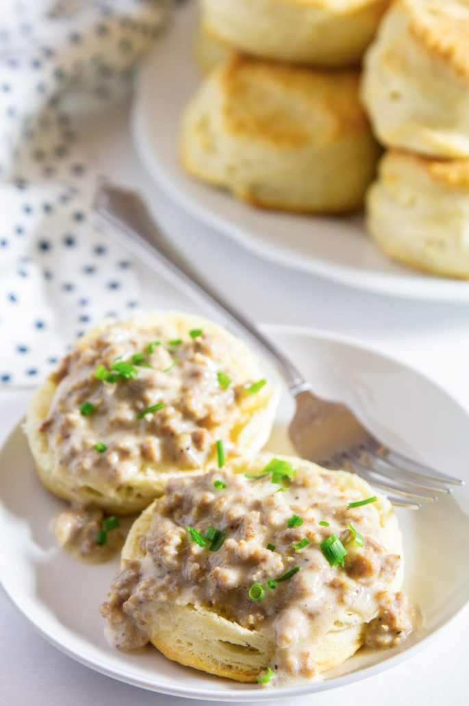 biscuits and gravy on a plate with a fork