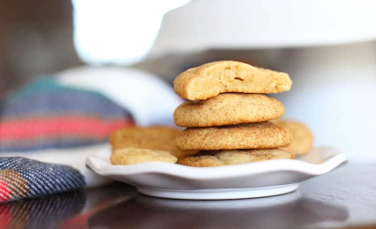 Snickerdoodle cookies stacked on a plate.