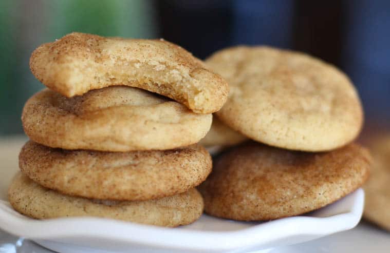 Soft and chewy snickerdoodle cookies with bite taken out.