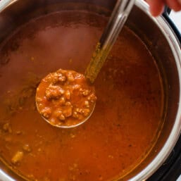 spaghetti sauce being ladled out of the Instant Pot