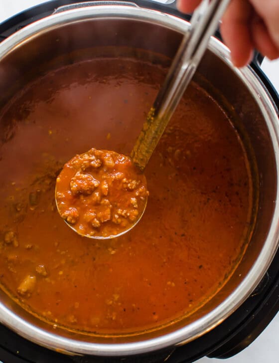 spaghetti sauce being ladled out of the Instant Pot