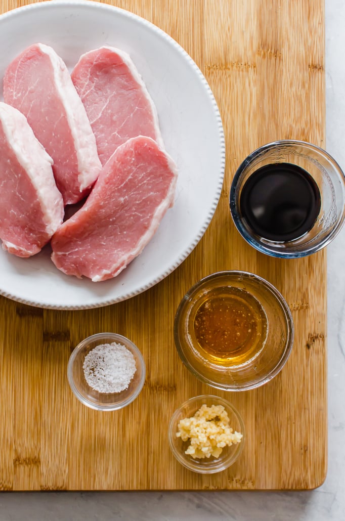 Raw boneless pork chops with marinade ingredients 