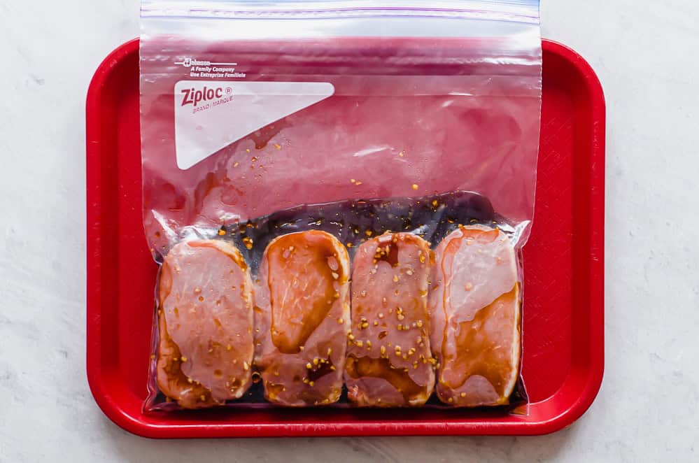 Boneless pork chops with sweet & savory marinade in a freezer bag.