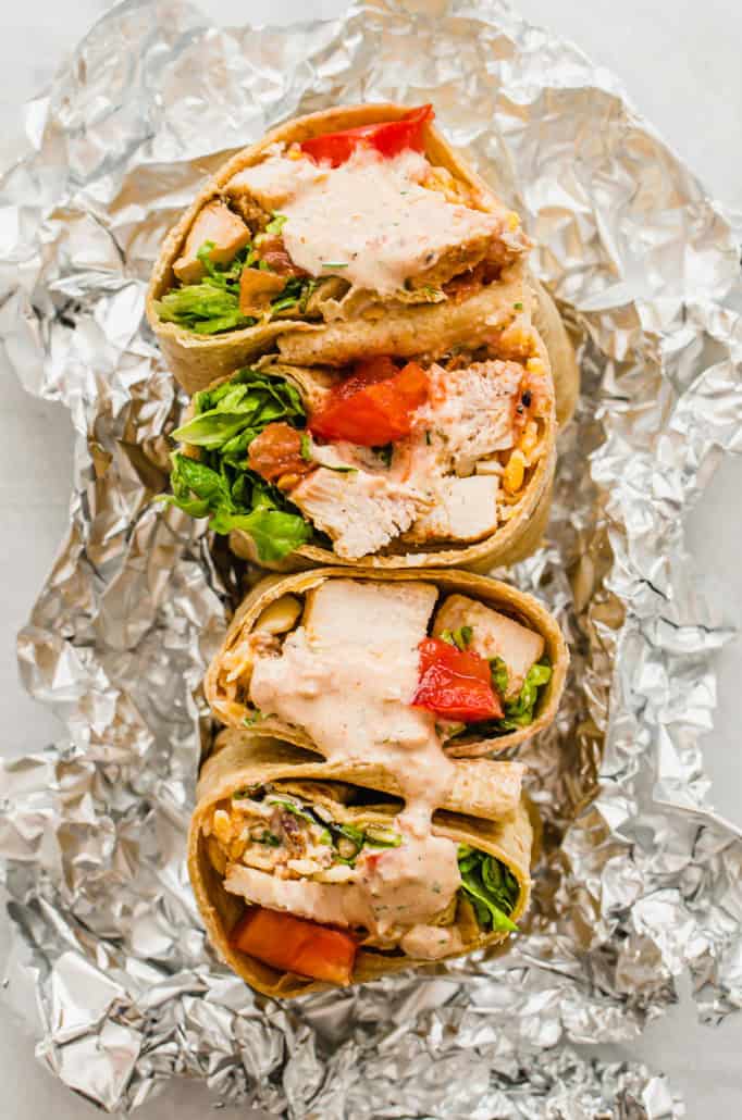 southwest chicken wraps cut in half on foil