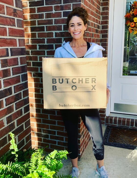 Woman holding a ButcherBox box