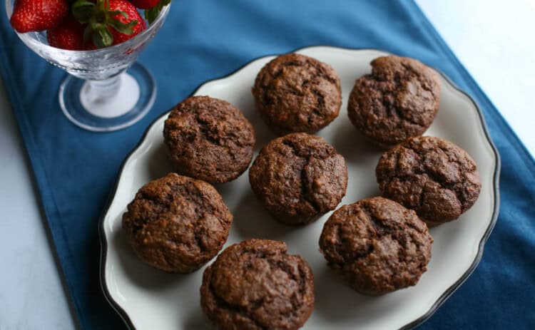 Chocolate banana muffins on a white plate.