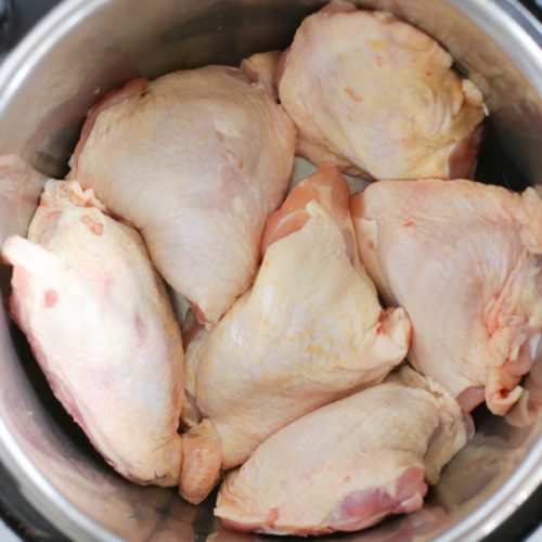 Uncooked chicken thighs in an Instant Pot.