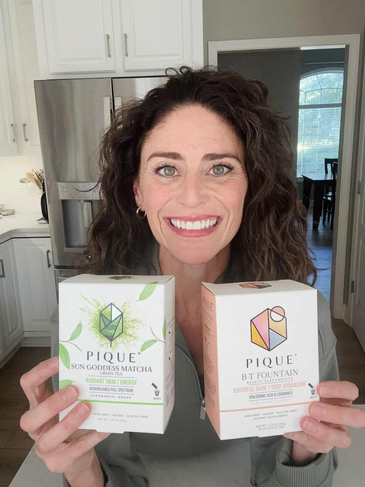 Rachel holding Pique Matcha Green Tea and Pique B.T. Fountain electrolytes.