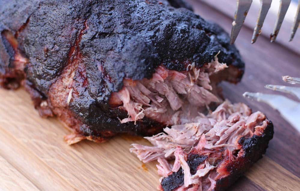 Smoked pork shoulder being shredded. 